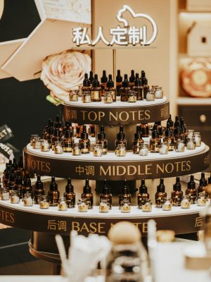 Luxurious perfume display with top, middle, and base notes bottles indoors.